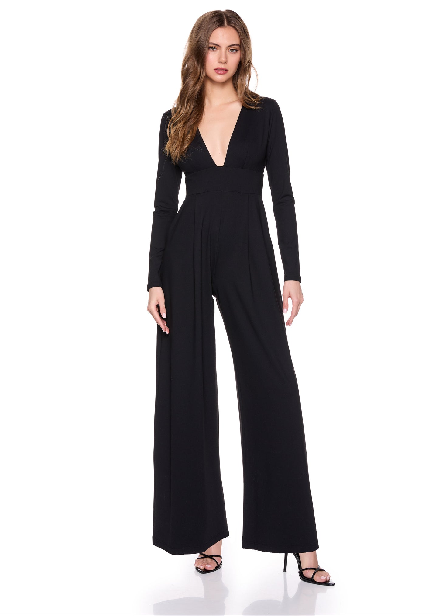 A woman wearing the Susana Monaco Very V Long Sleeve Jumpsuit
