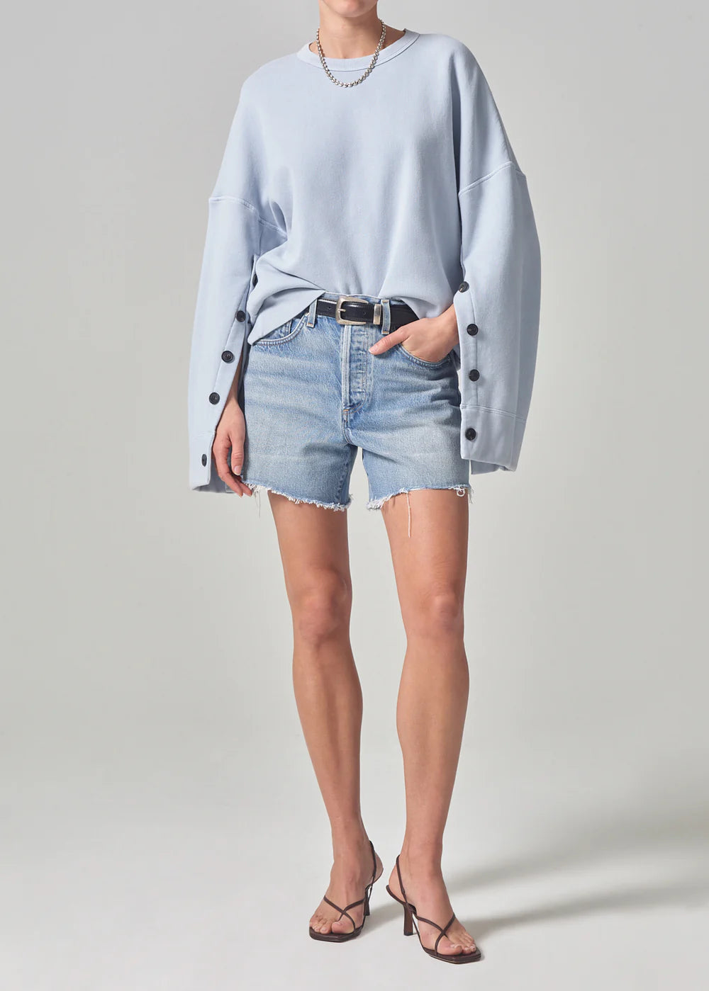 Front view of model wearing the gemini light wash Annabelle Long Short by Citizens of Humanity
