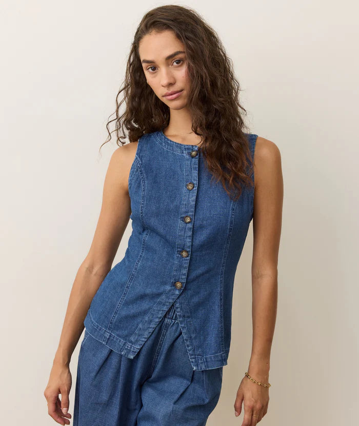 A woman wearing the Marine Layer Charlie Longline Vest in Medium Wash.