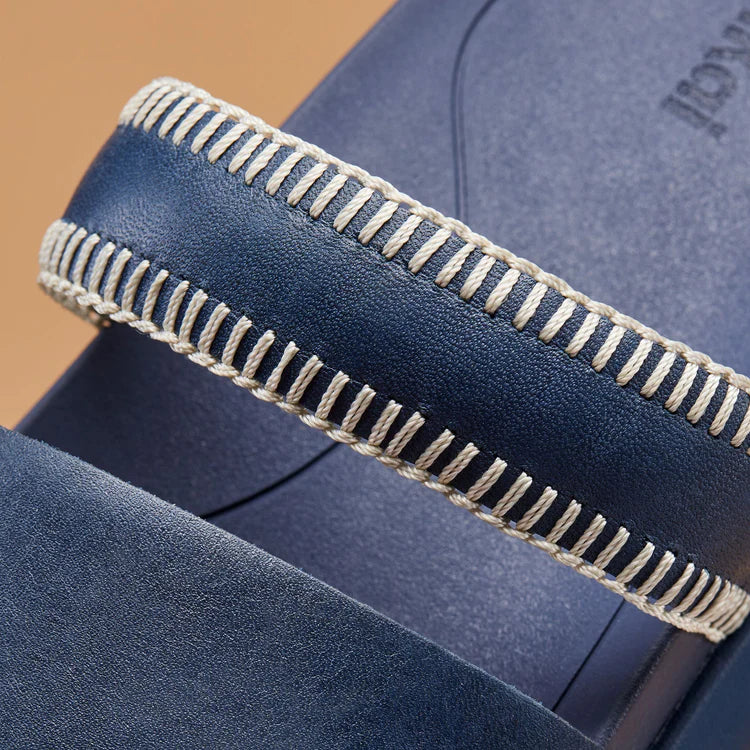 The OluKai Pae Women's Leather Slide Sandals feature handcrafted details that blend tradition with contemporary design