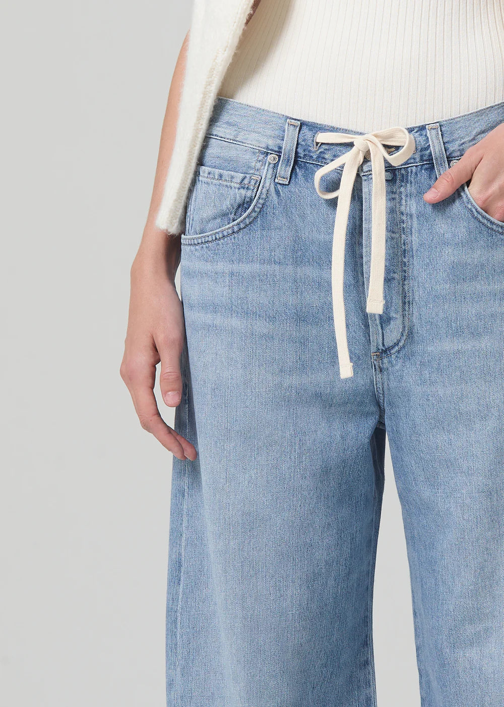 Close up view of the drawstring closure on the light indigo Brynn Drawstring Trouser by Citizens of Humanity