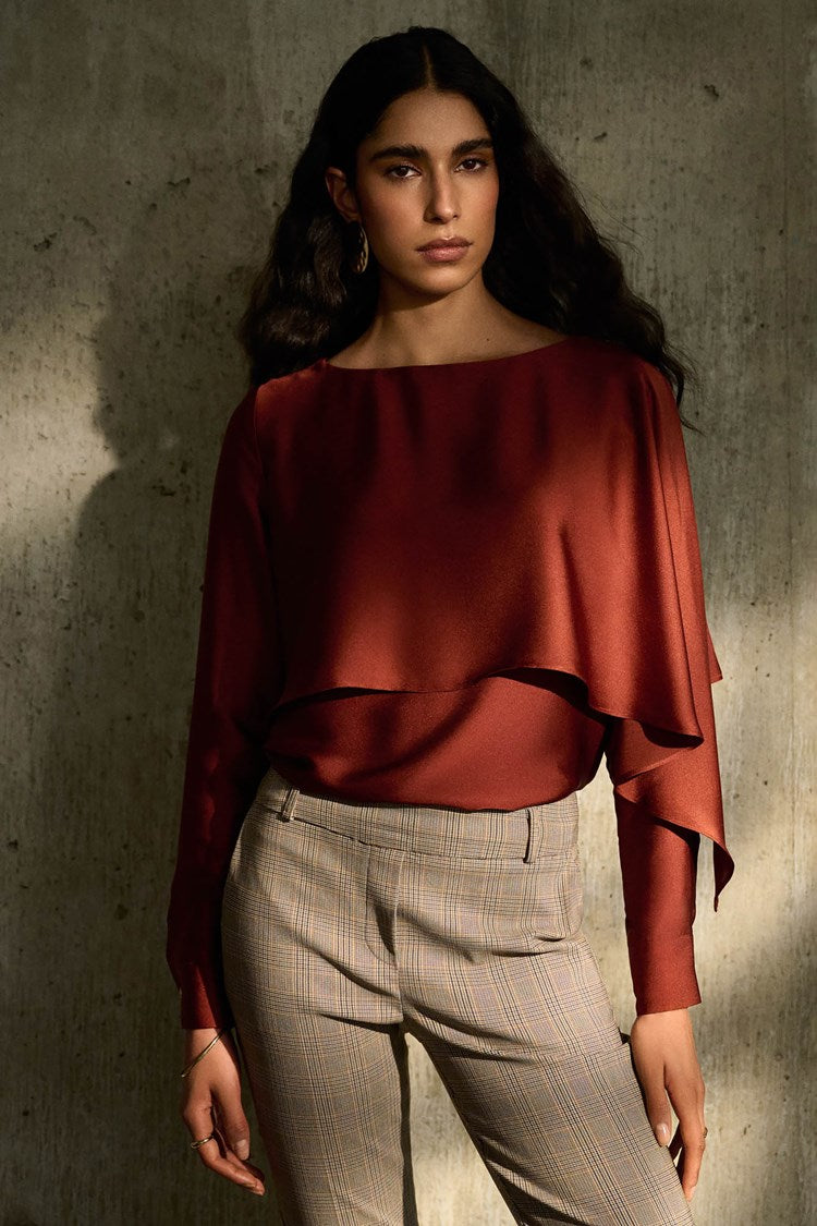 Model posing wearing the Cinnamon Satin Flared Cape Top by Joseph Ribkoff