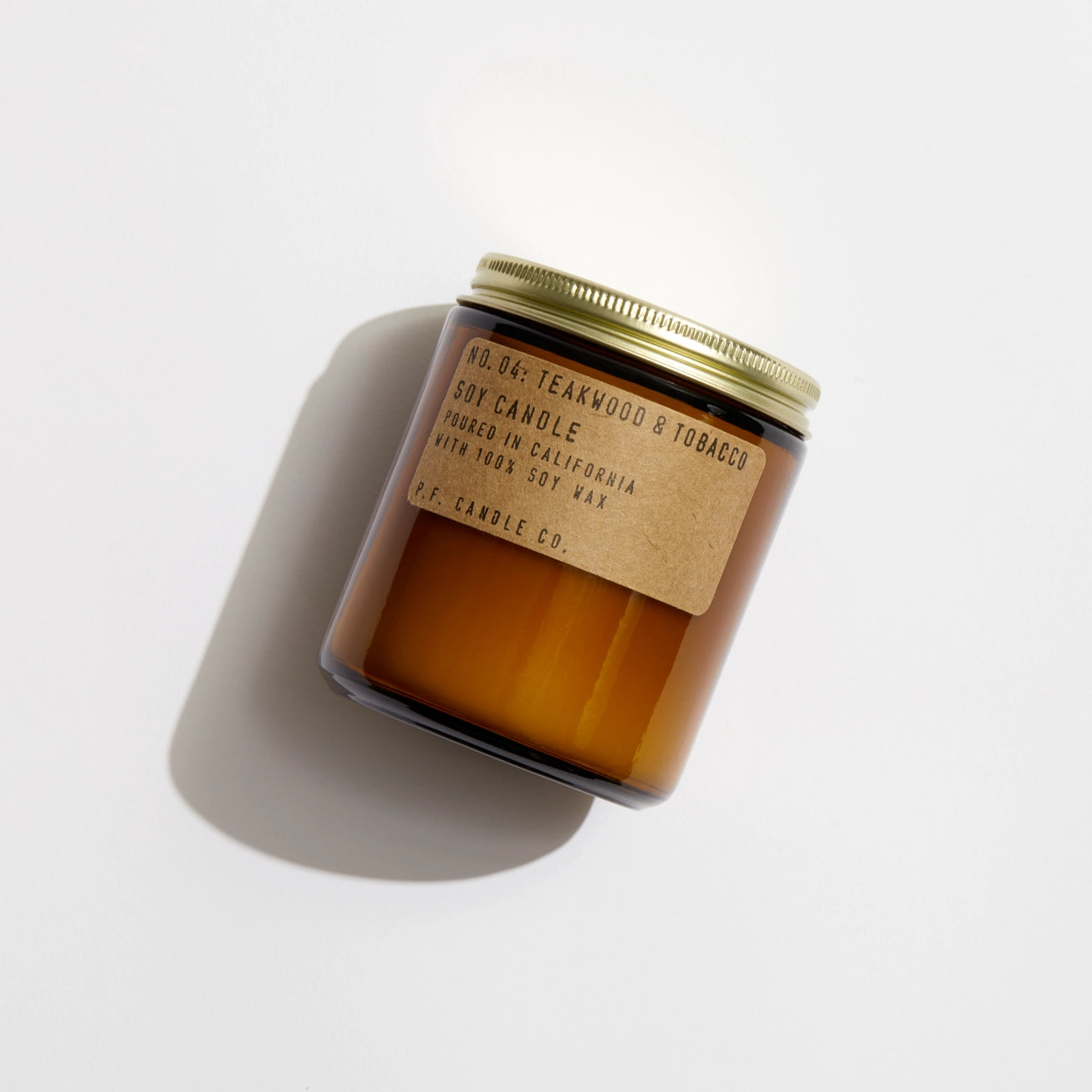 Flat lay of P.F. Candle Co. Teakwood & Tobacco Soy Candle - 7.2oz