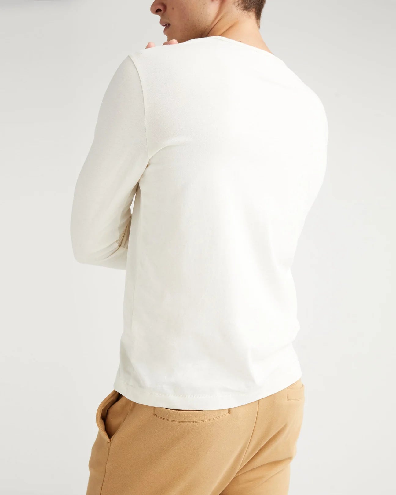 Back view of a man wearing the Weighted Organic Cotton Long Sleeve Tee by Richer Poorer in the color Bone