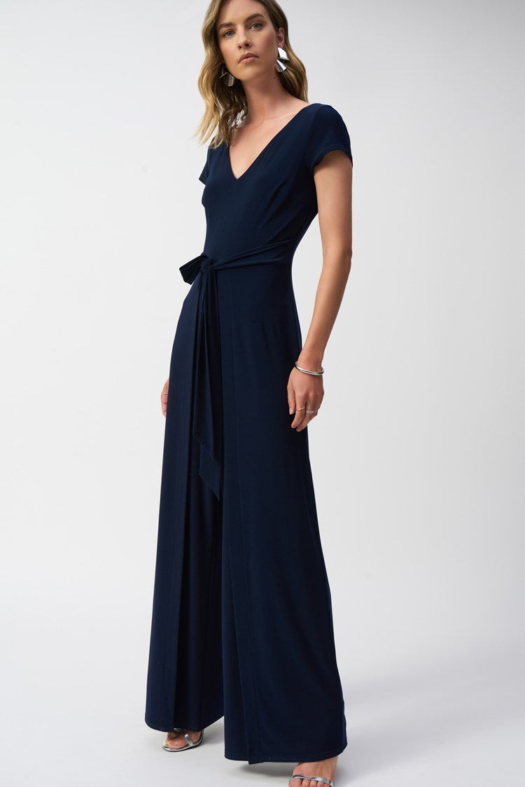 The luxurious Silky Knit Wide-Leg Jumpsuit by Joseph Ribkoff with a flattering V-neckline and a waist-cinching sash for added elegance