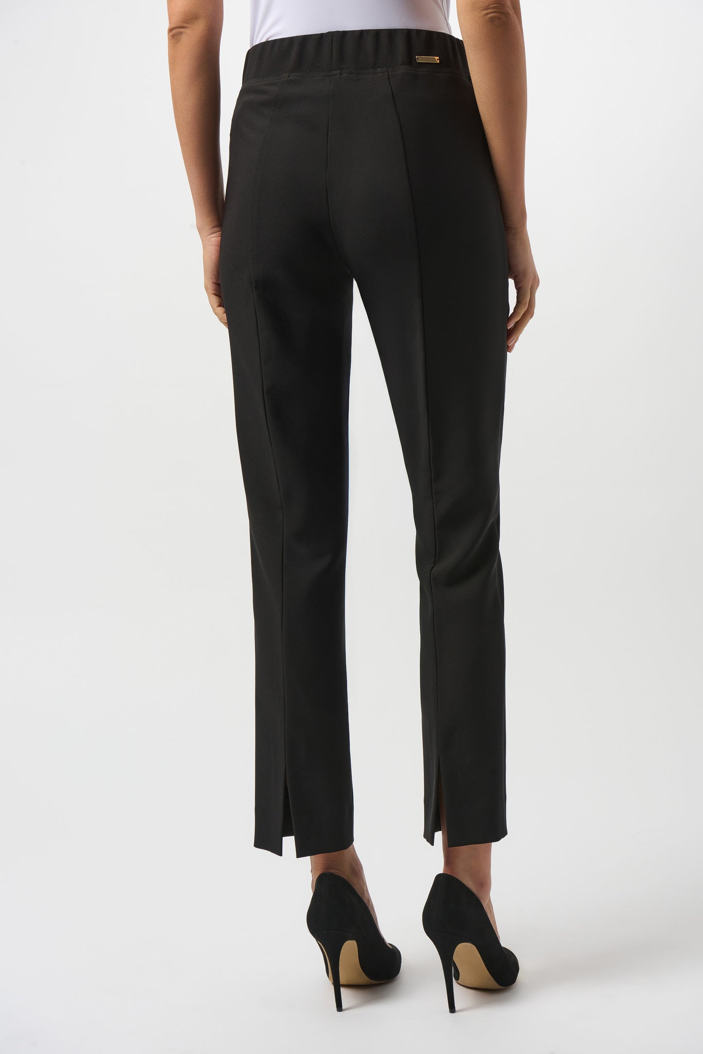 Women's black straight leg pants with back slits at the bottom hem