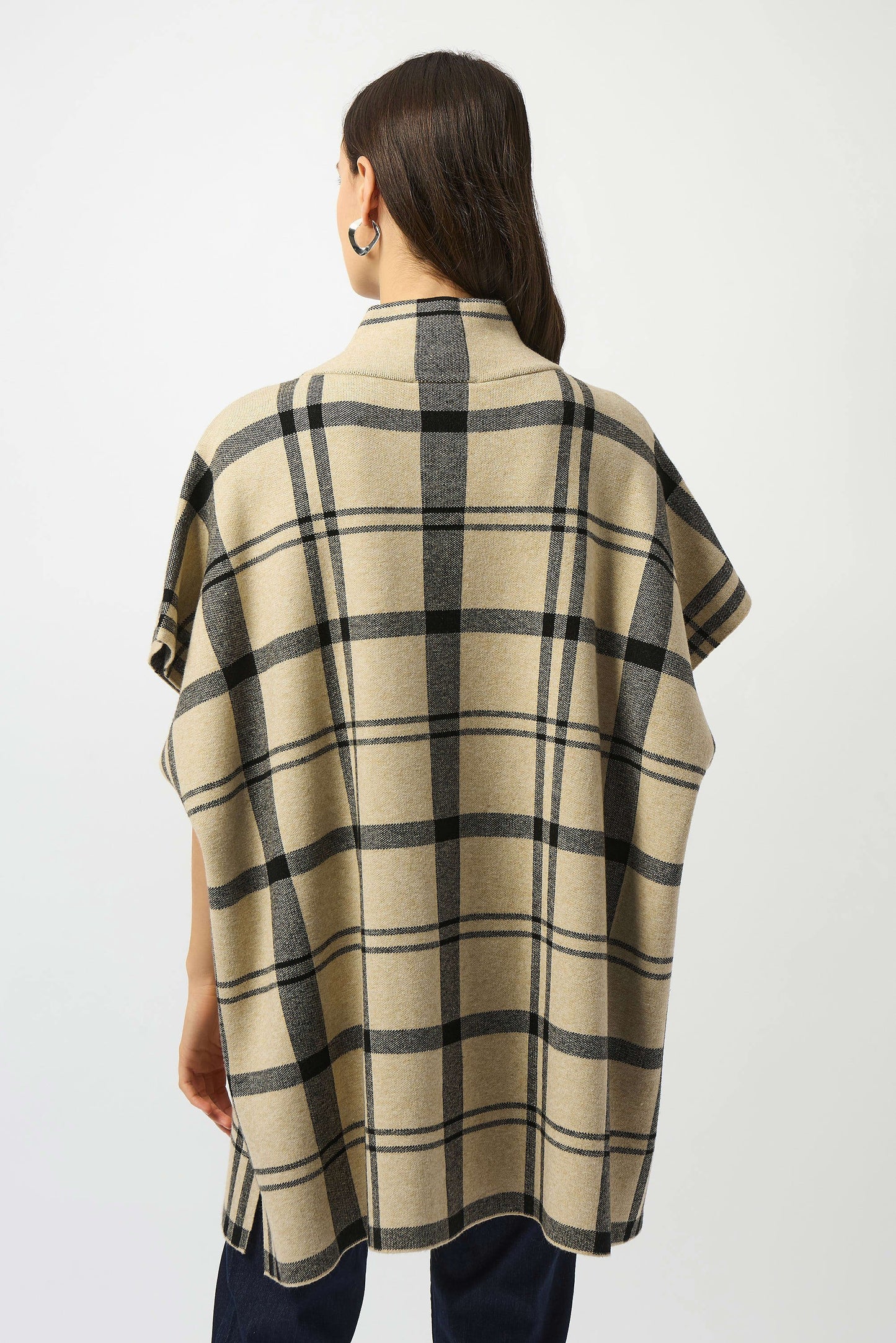 Woman wearing a plaid poncho top by Joseph Ribkoff.
