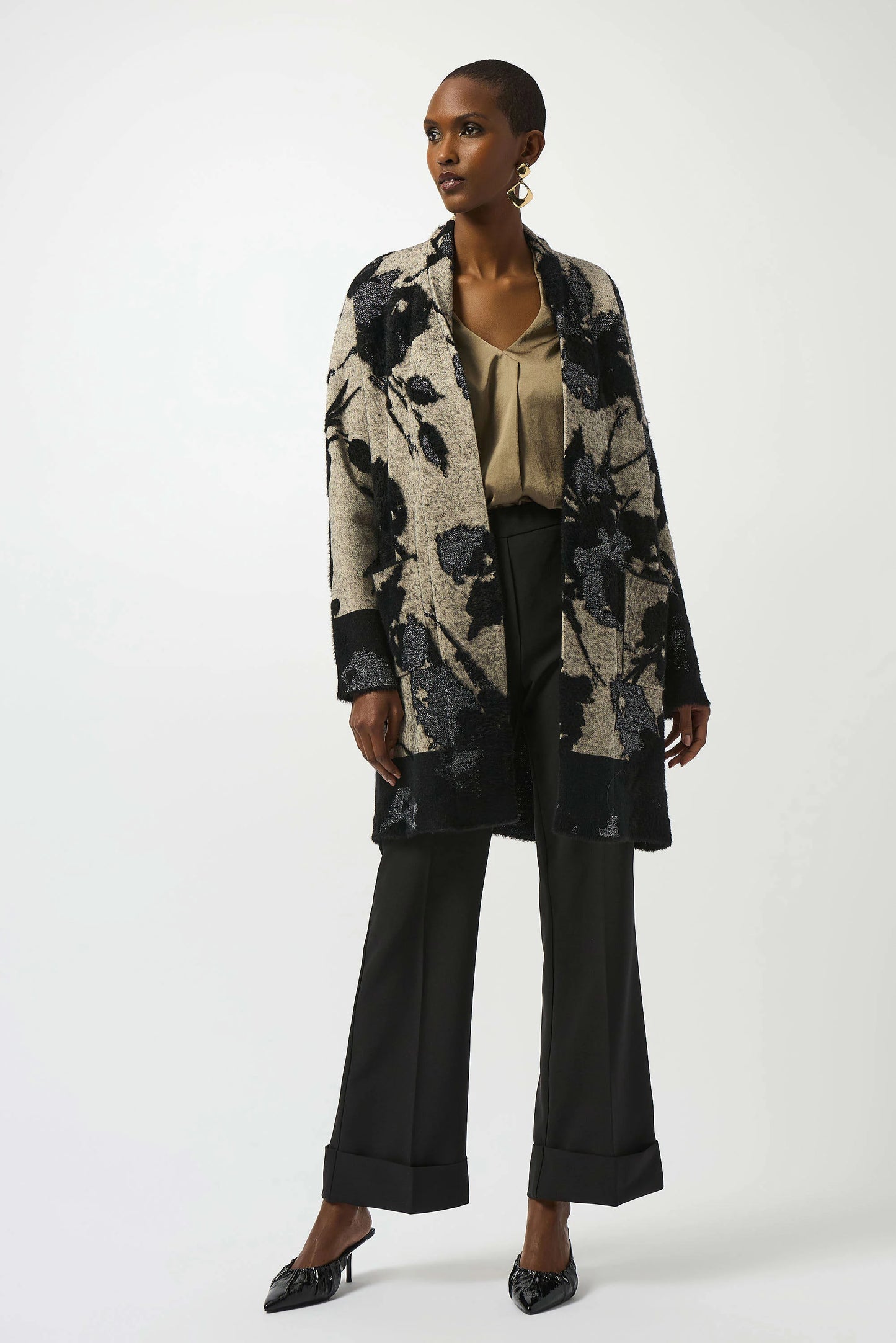 Woman wearing a floral cardigan and black pants from Joseph Ribkoff