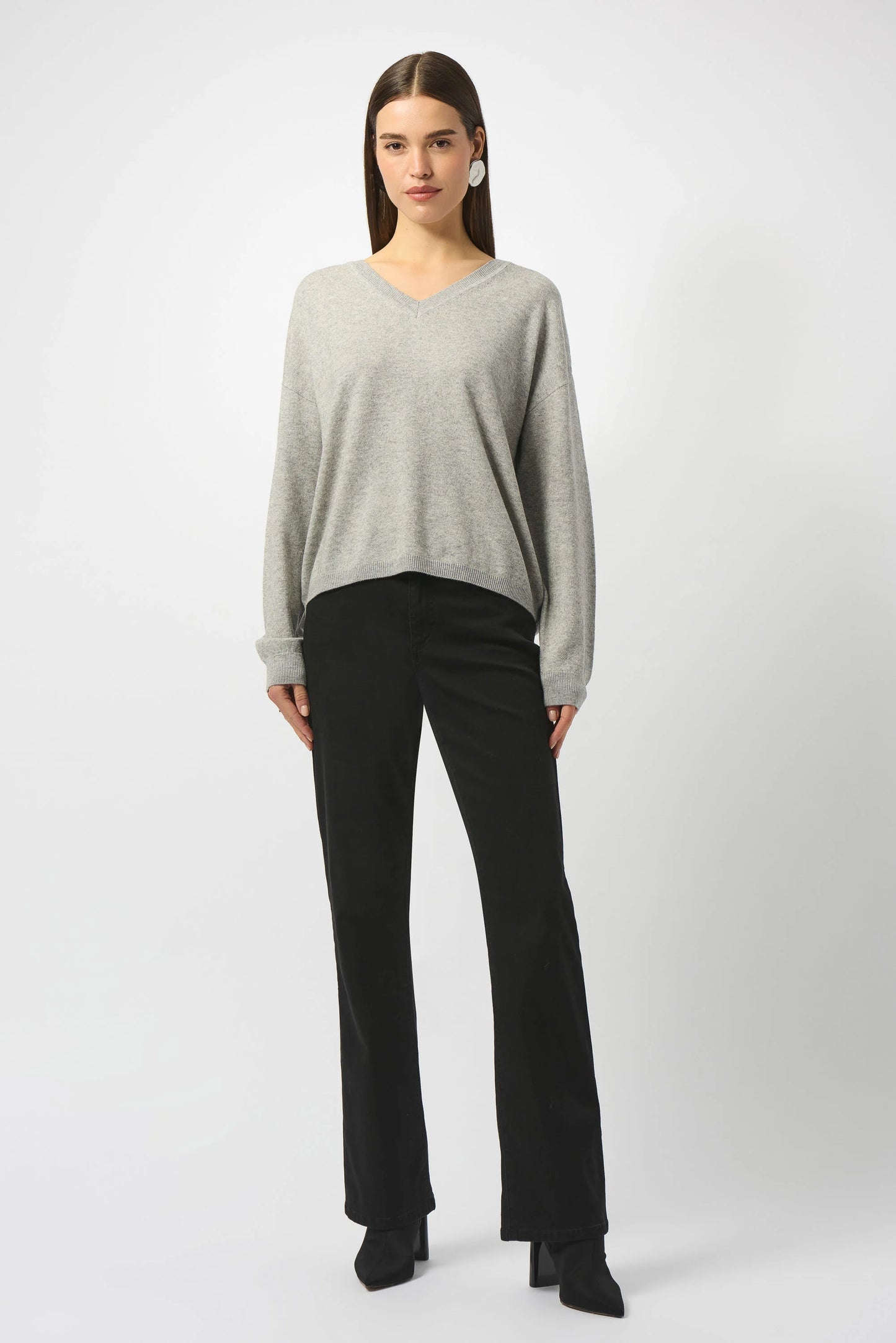 Woman wearing a gray sweater and black pants from Joseph Ribkoff