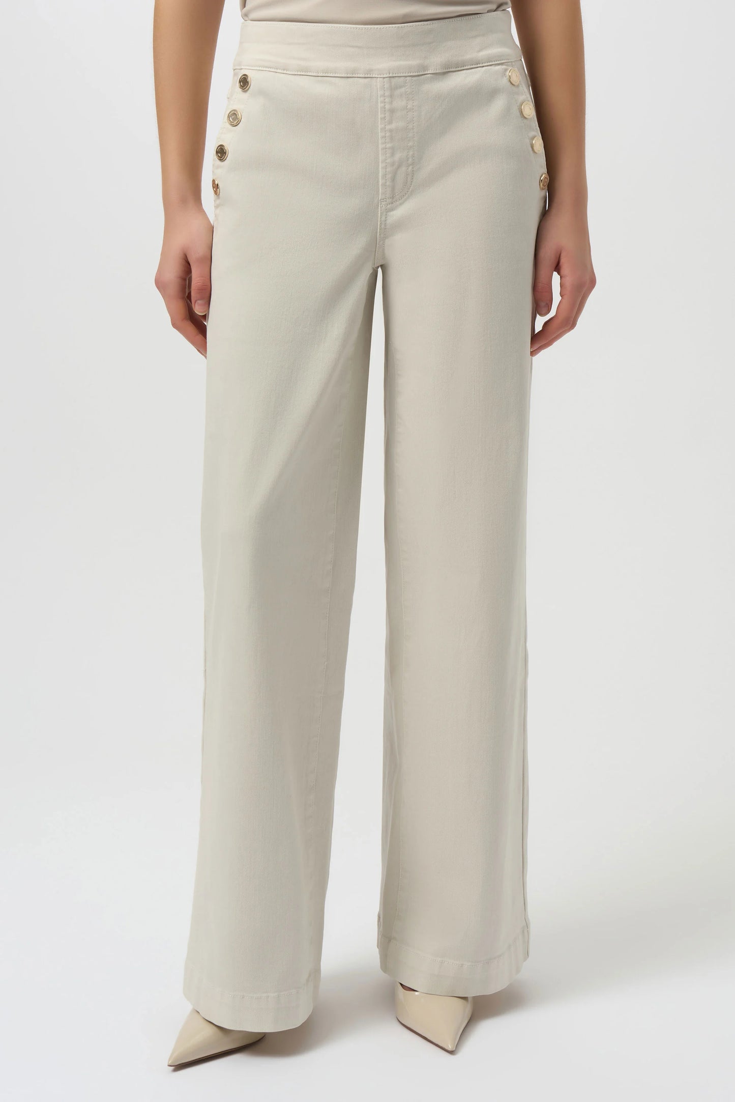 Women's light khaki pull on jeans with button details along the pockets