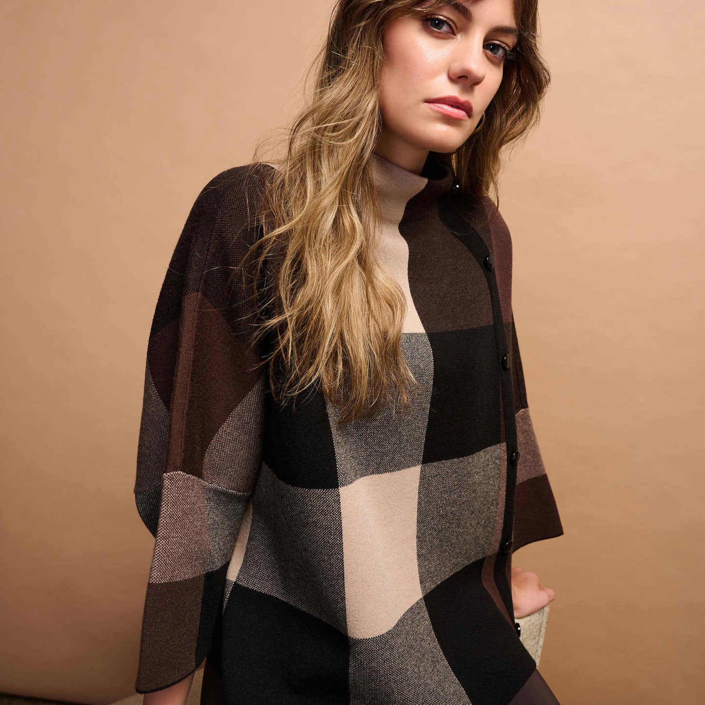 Woman wearing a checkered sweater from Joseph Ribkoff