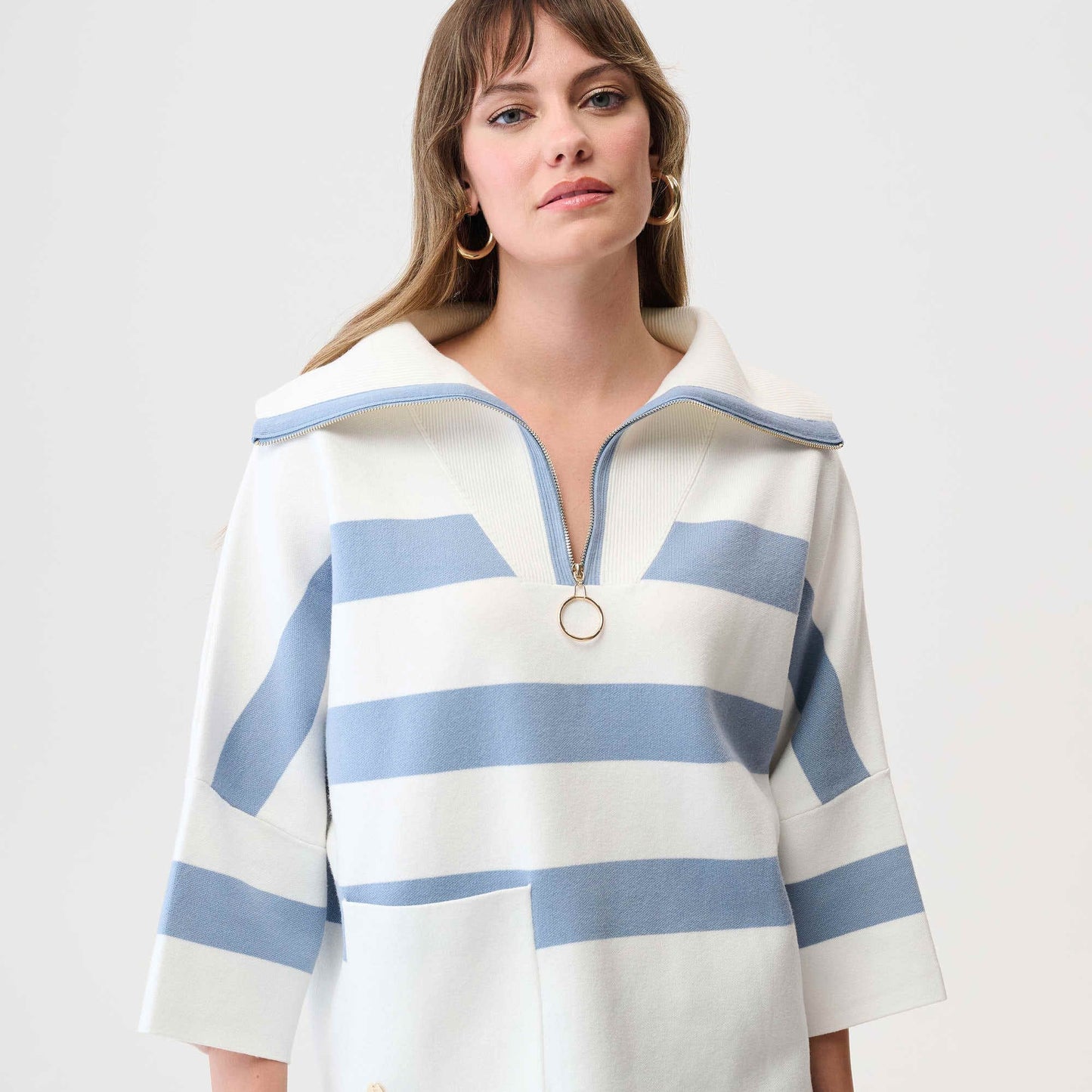 Woman wearing a white and blue striped zip collar sweater shirt from Joseph Ribkoff