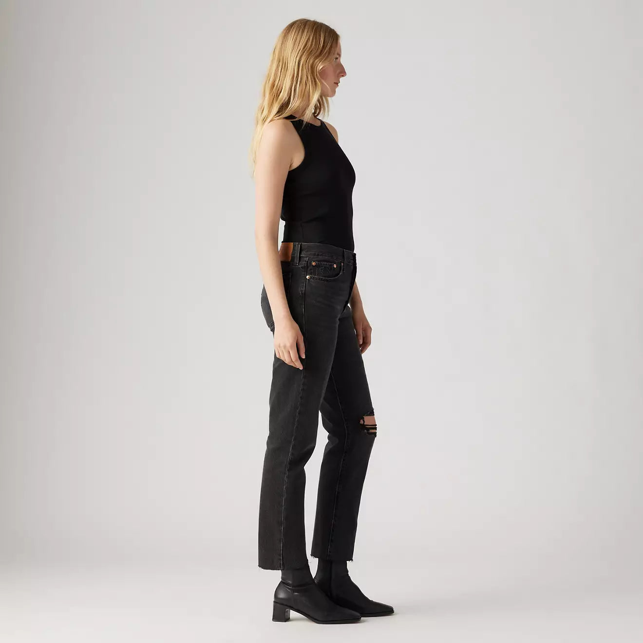 Side view of a woman wearing Levi's Wedgie Straight Women's Jeans in the color After Sunset