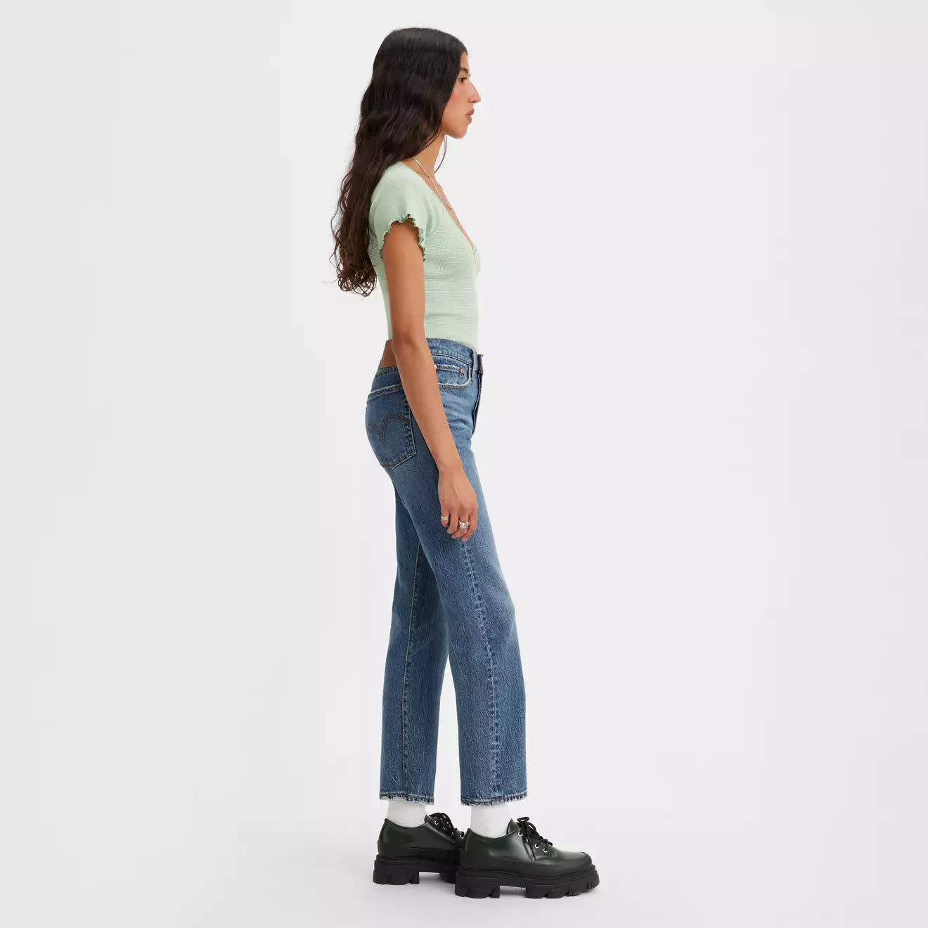Side view of a woman wearing the Unstoppable Wear Dark Wash Wedgie Straight Women's Jeans by Levi's