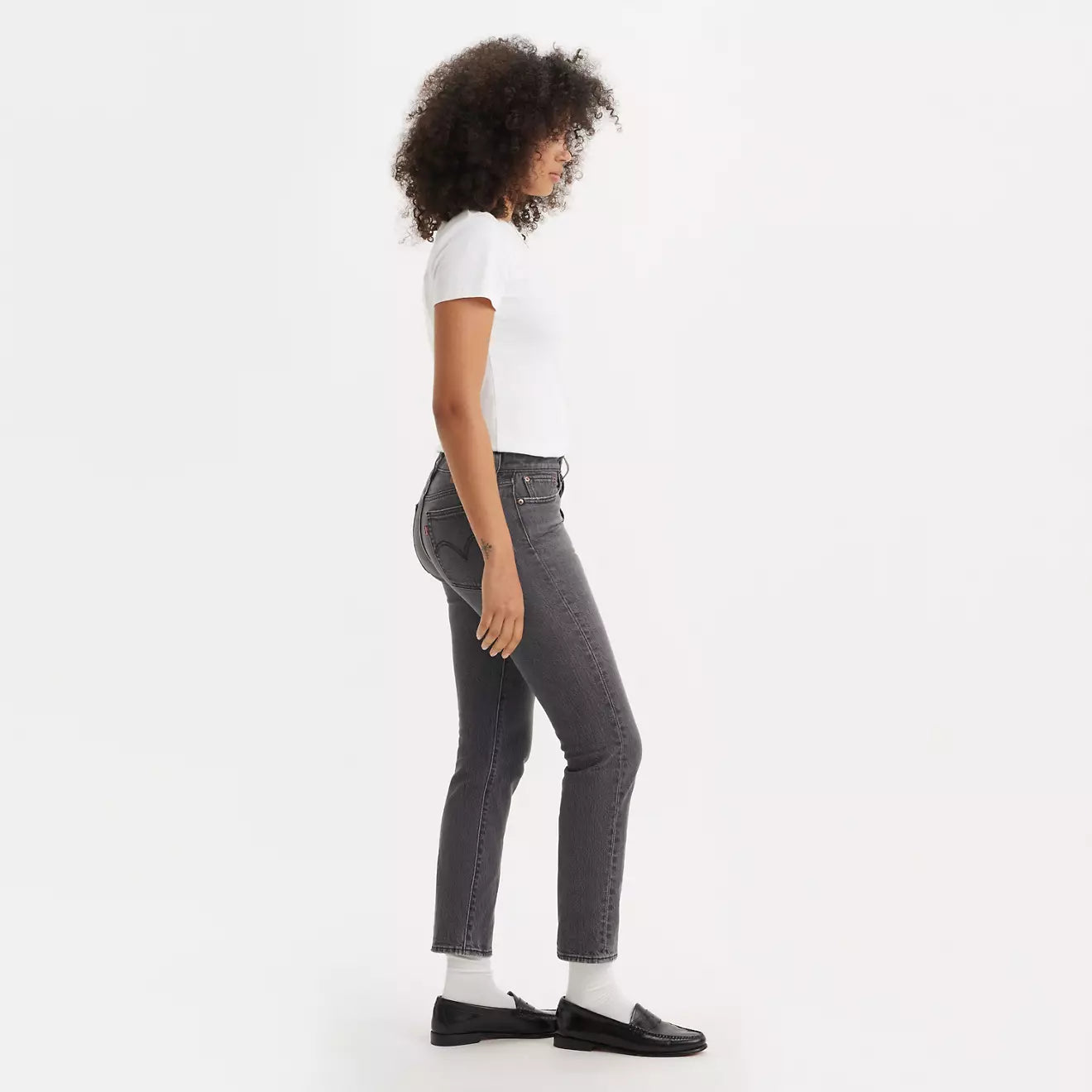 Side view of a woman wearing the  Well Worn Black Wedgie Straight Women's Jeans by Levi's