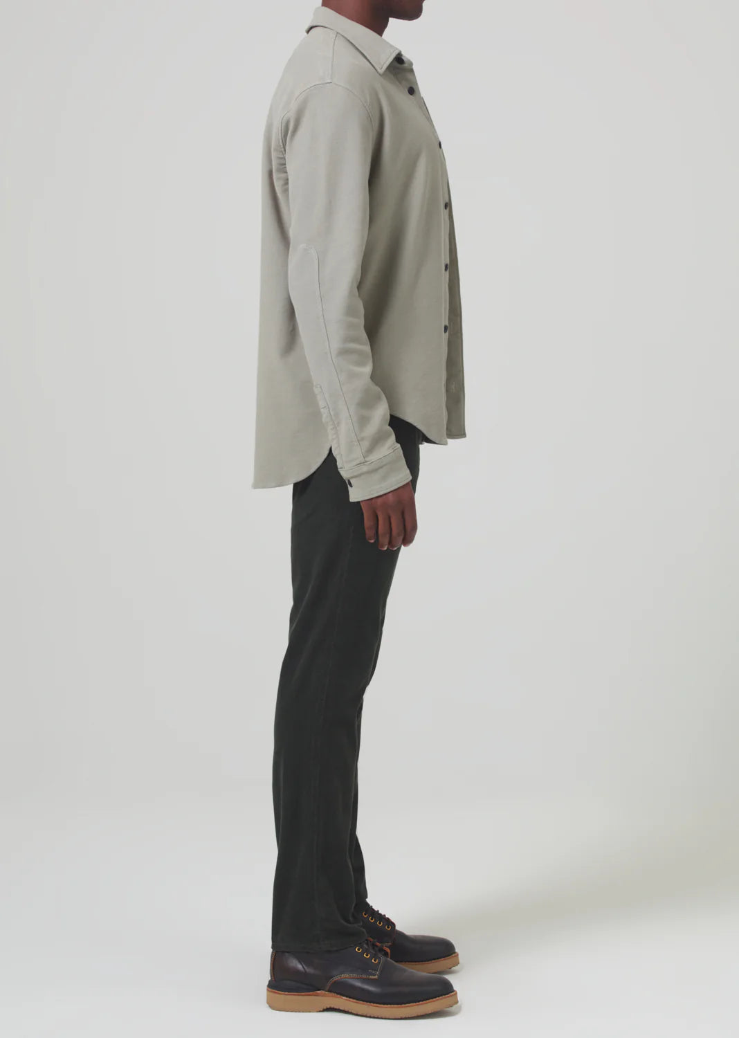 Side view of a man wearing the Dark Green Gage Slim Straight Corduroy men's pants by Citizens Of Humanity