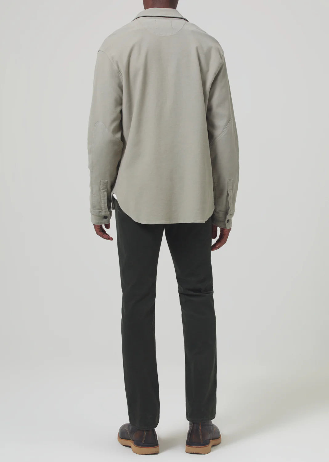 Back view of a man wearing the Dark Green Gage Slim Straight Corduroy men's pants by Citizens Of Humanity