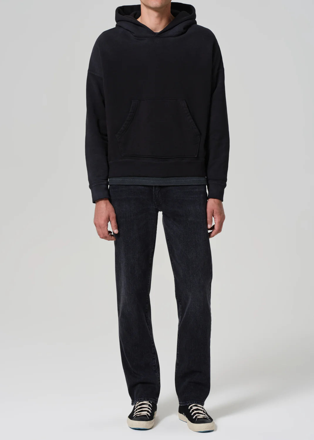 A man wearing the Elijah Straight Archive Men's Jeans in the color Grotto