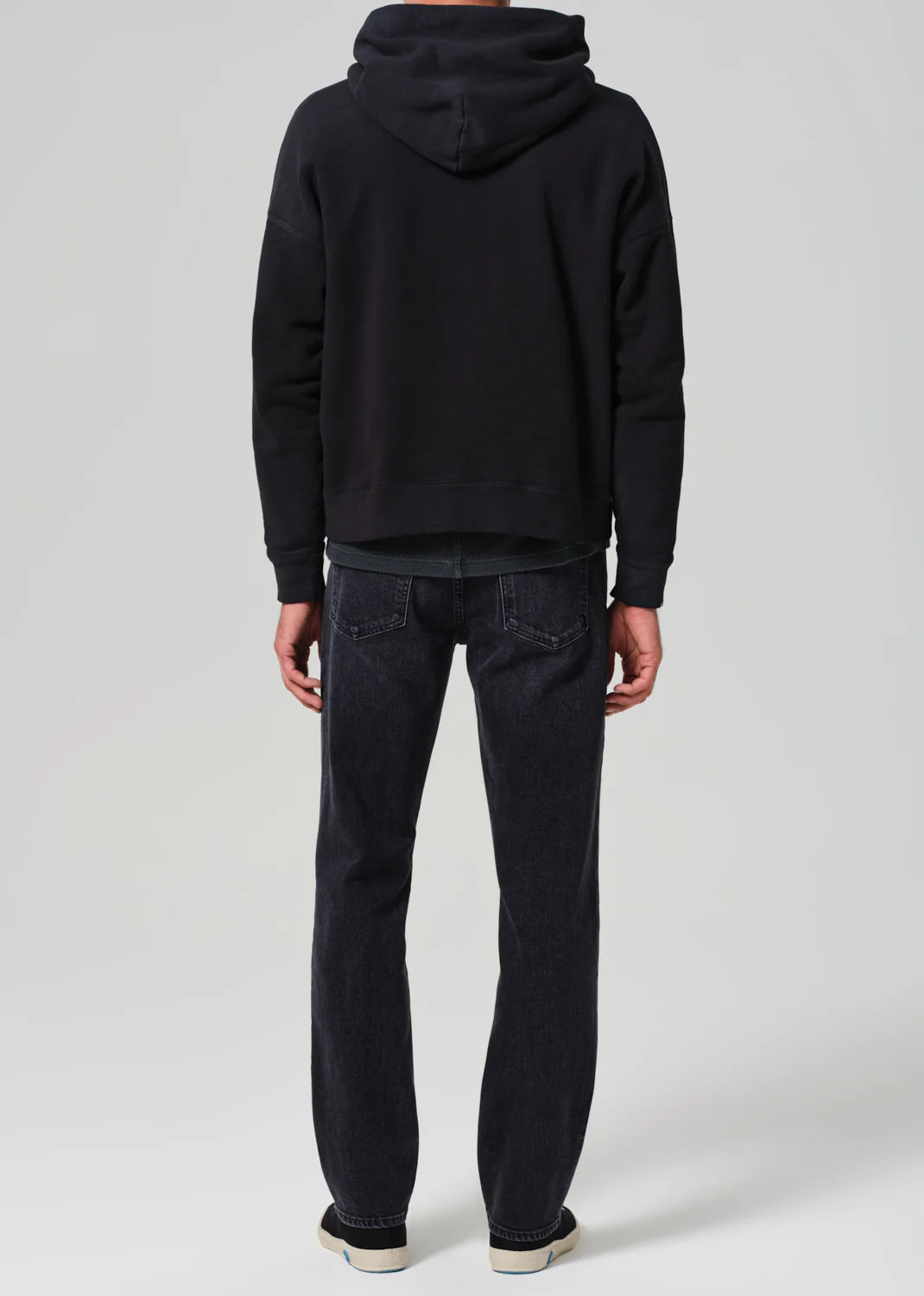Back view of a man wearing the Elijah Straight Archive Men's Jeans in the color Grotto