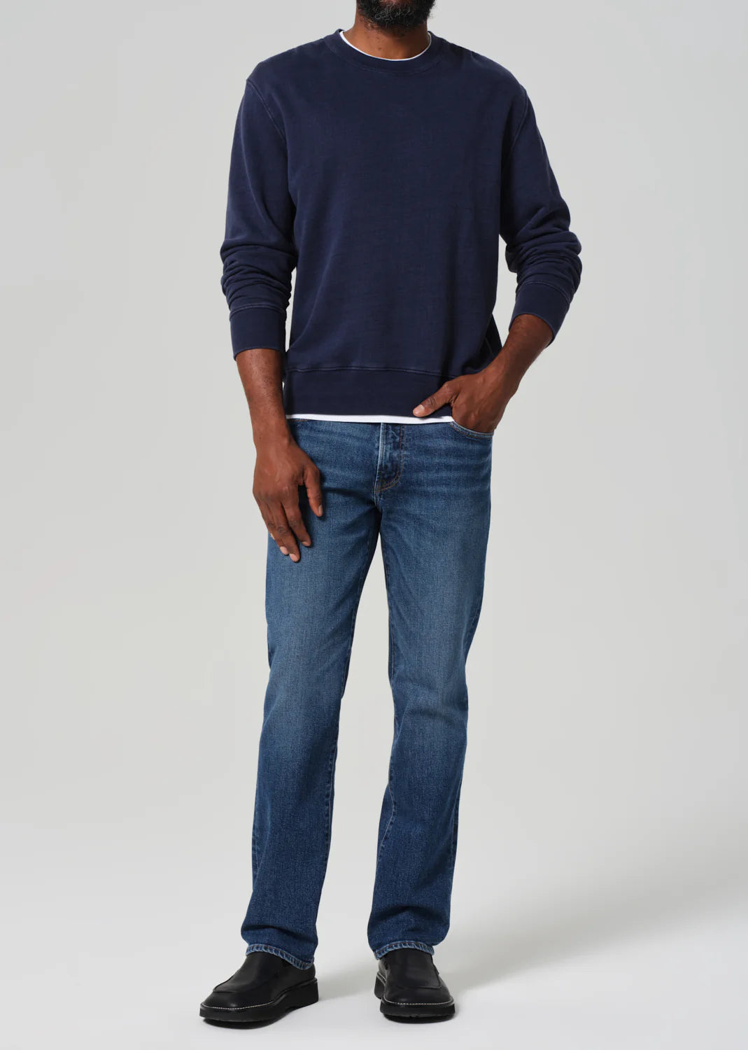 A man wearing the Elijah Straight Archive Men's Jeans in the color Falling Water