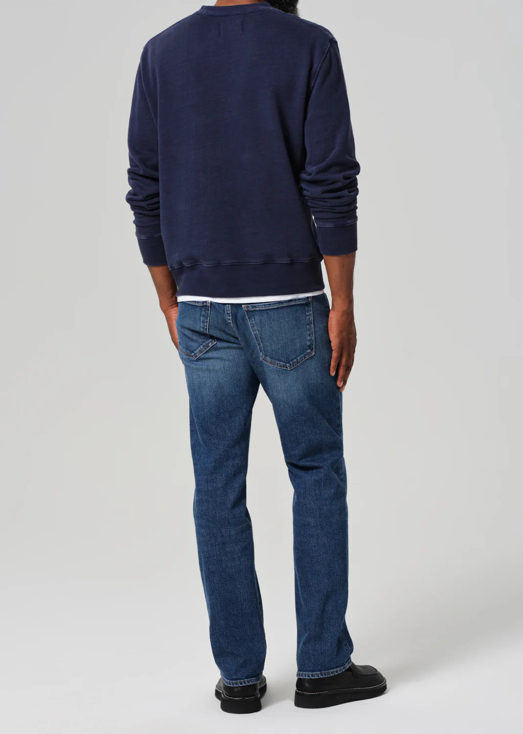 Back view of a man wearing the Elijah Straight Archive Men's Jeans in the color Falling Water