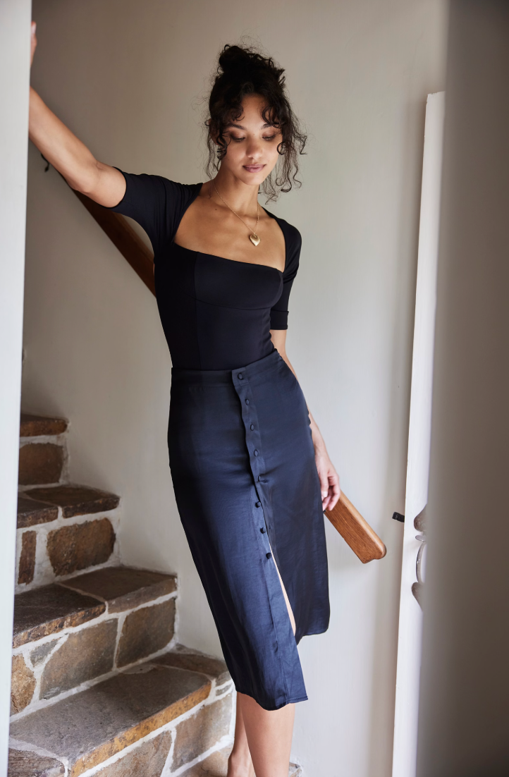 Free People's Everly Bodysuit paired with a pencil skirt.