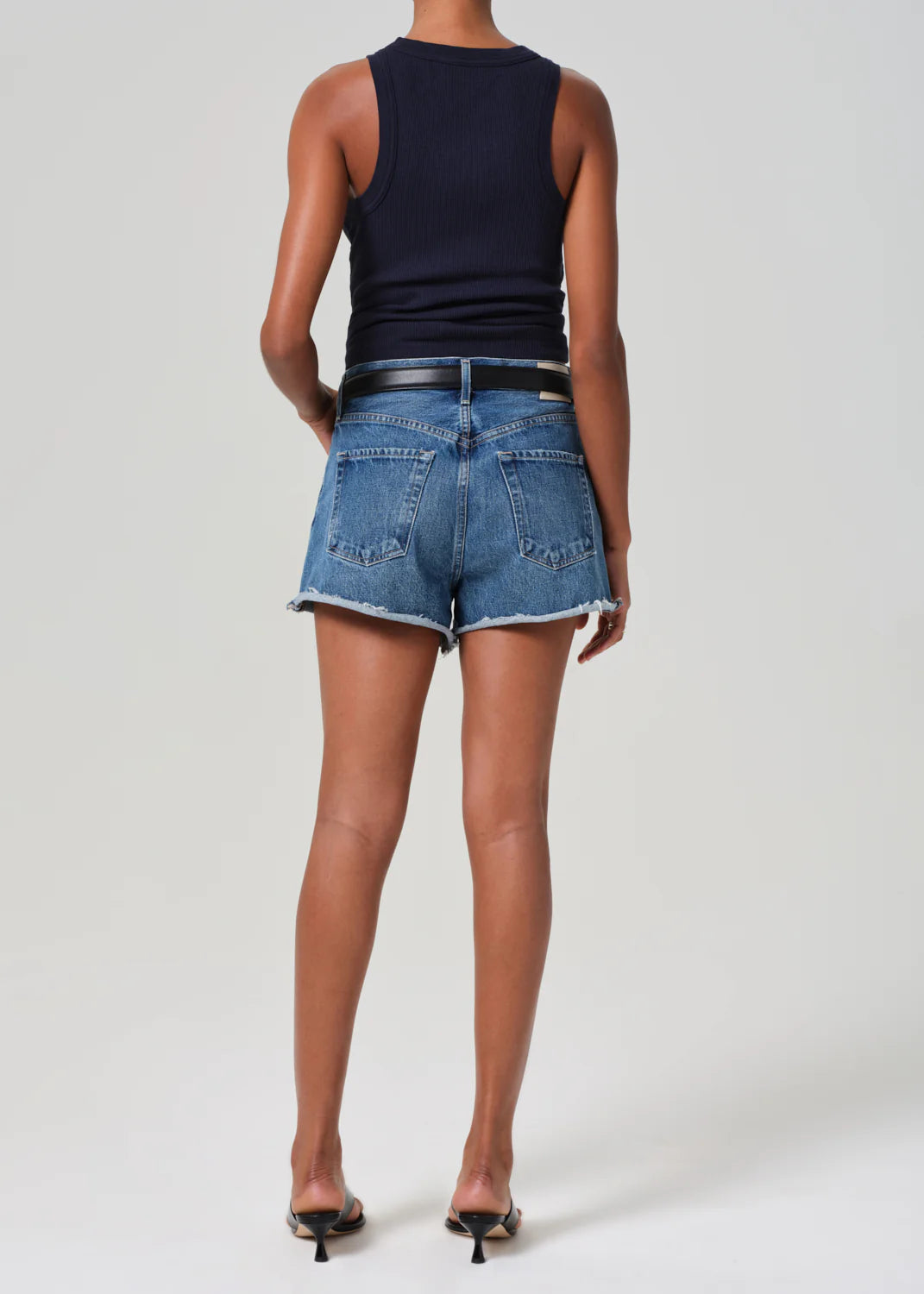 Women's mid-blue denim shorts with raw hem