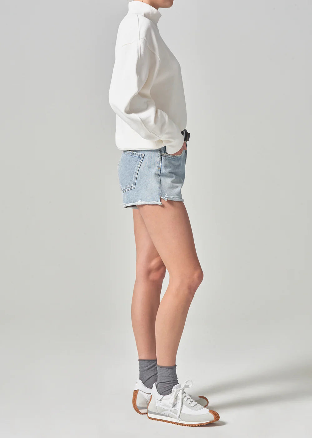 Side view of model wearing the women's light indigo Marlow Short by Citizens of Humanity