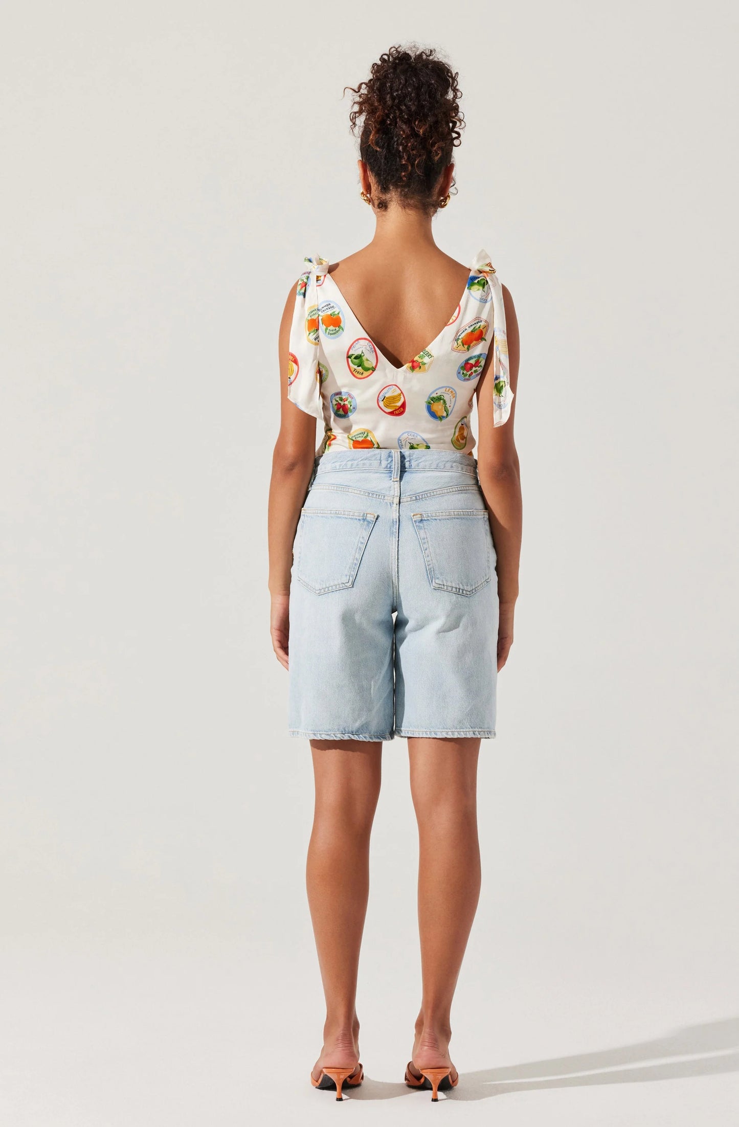 Shop women's tops for summer at Harbour Thread boutique! New arrivals include the ASTR Allexina Satin Tie-Shoulder Top in Ivory Fruit Cocktail.