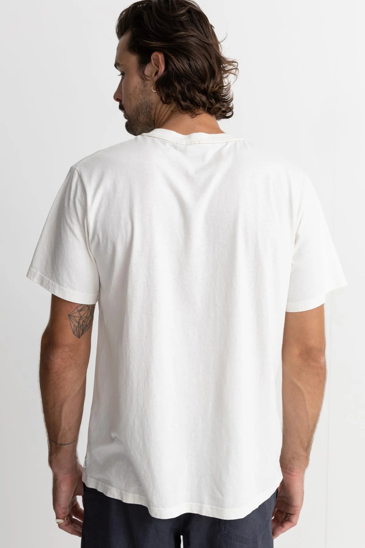 Back view of man wearing the Vintage White Classic Vintage Tee by Rhythm