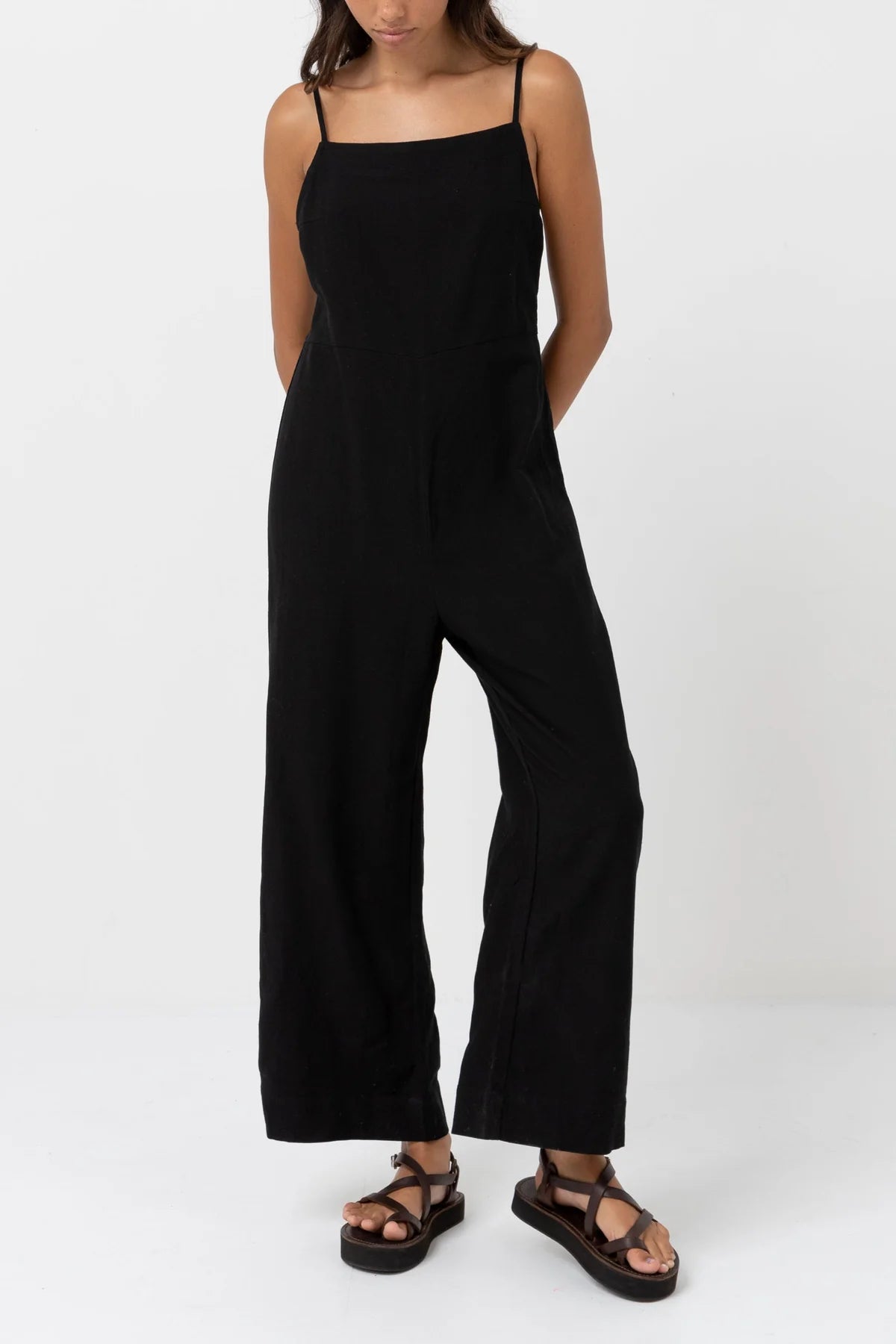Front view of woman wearing a black, linen blend wide leg jumpsuit