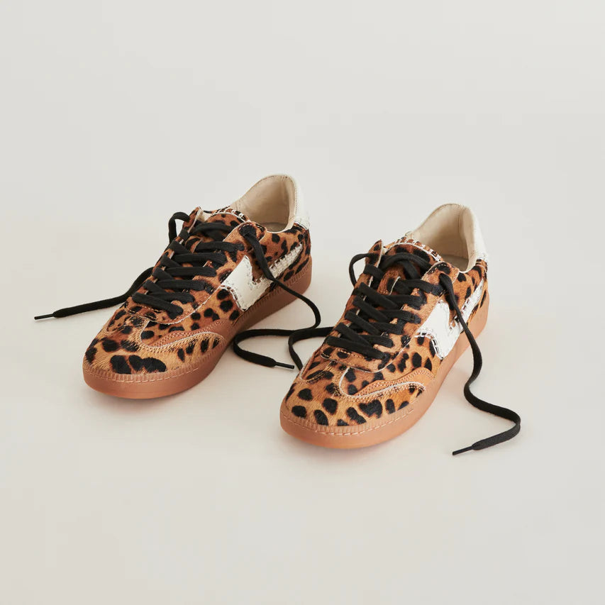 A pair of the Notice Stitch Sneakers in Dark Leopard Calf Hair with untied laces