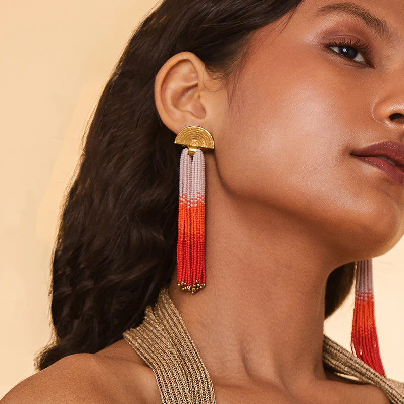 A woman wearing the Orange beaded Lalika Earrings by Deepa Gurnani