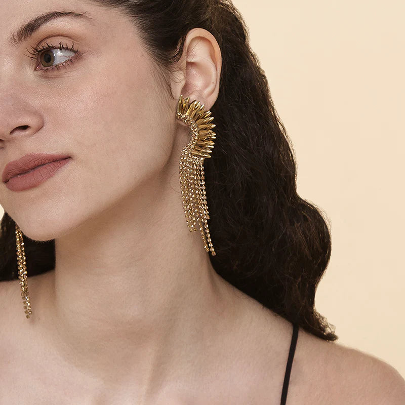 A woman wearing the Gold Estella Earrings by Deepa Gurnani