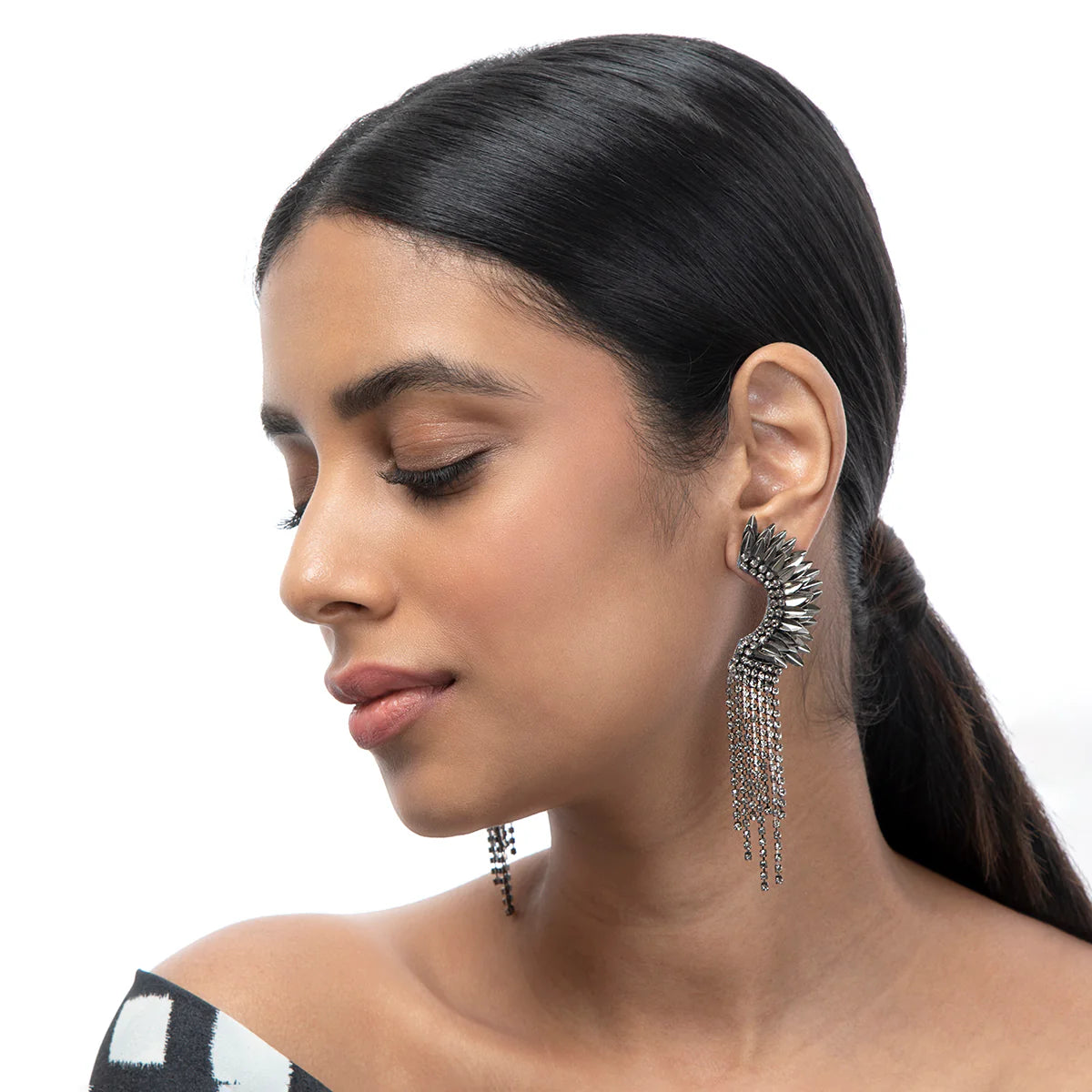 A woman wearing the Gunmetal Estella Earrings by Deepa Gurnani