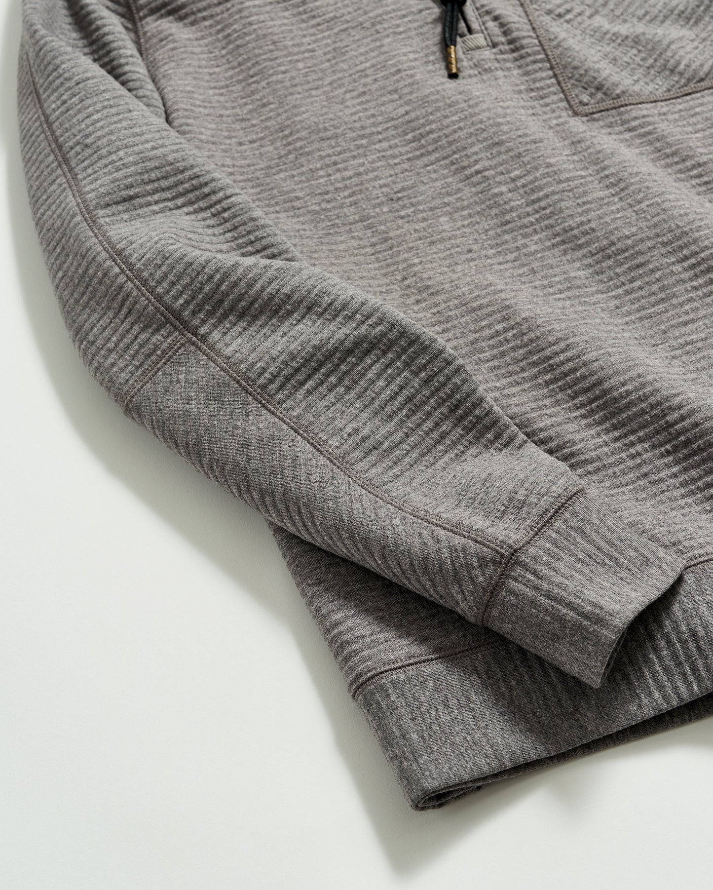 Close up of sleeves on a men's grey pullover