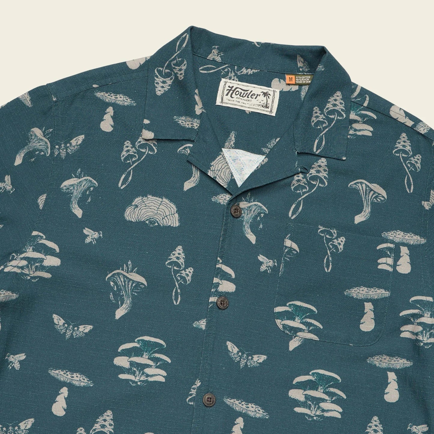 Teal shirt with white mushroom pattern by Howler Bros