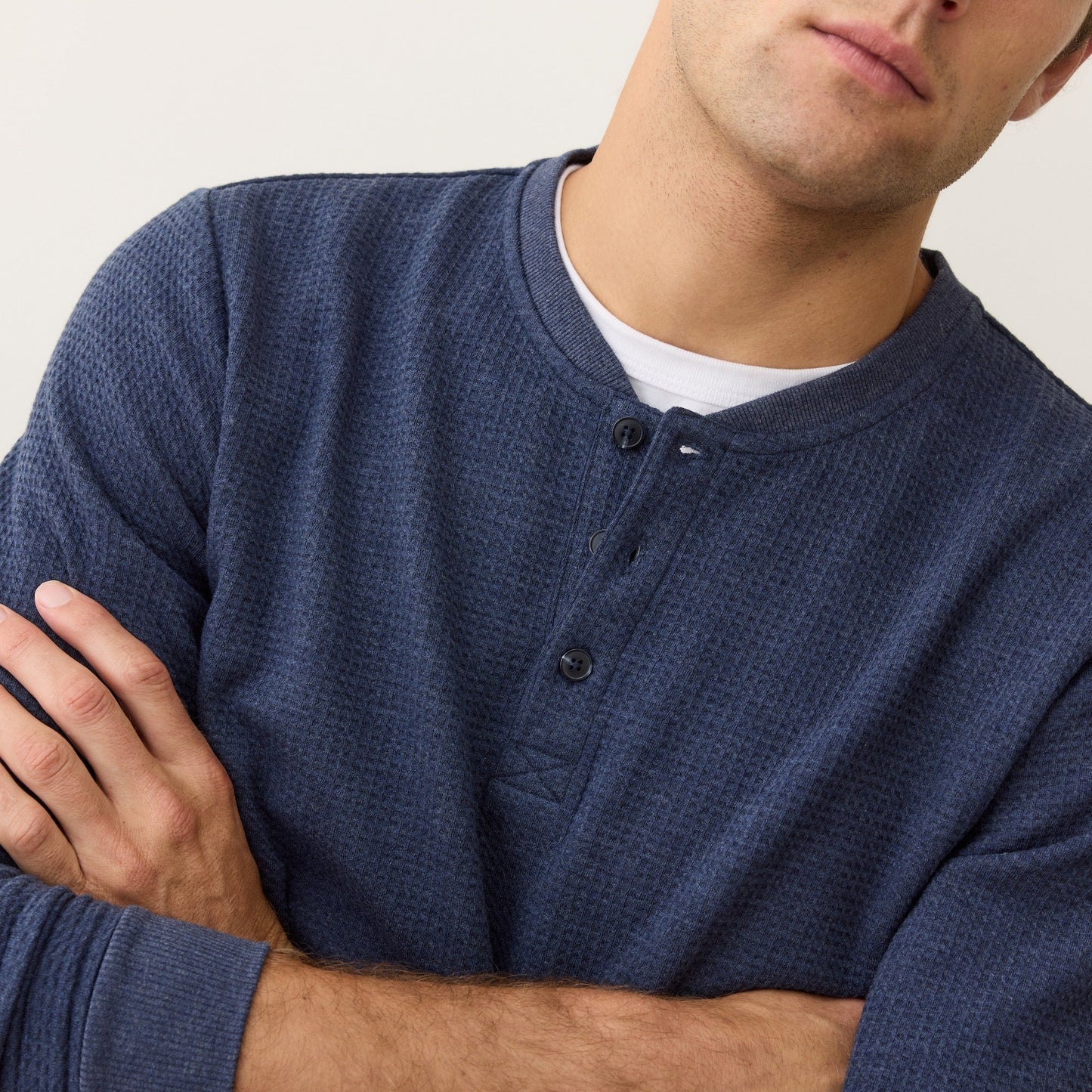 Man wearing a blue long-sleeve henley shirt from Marine Layer