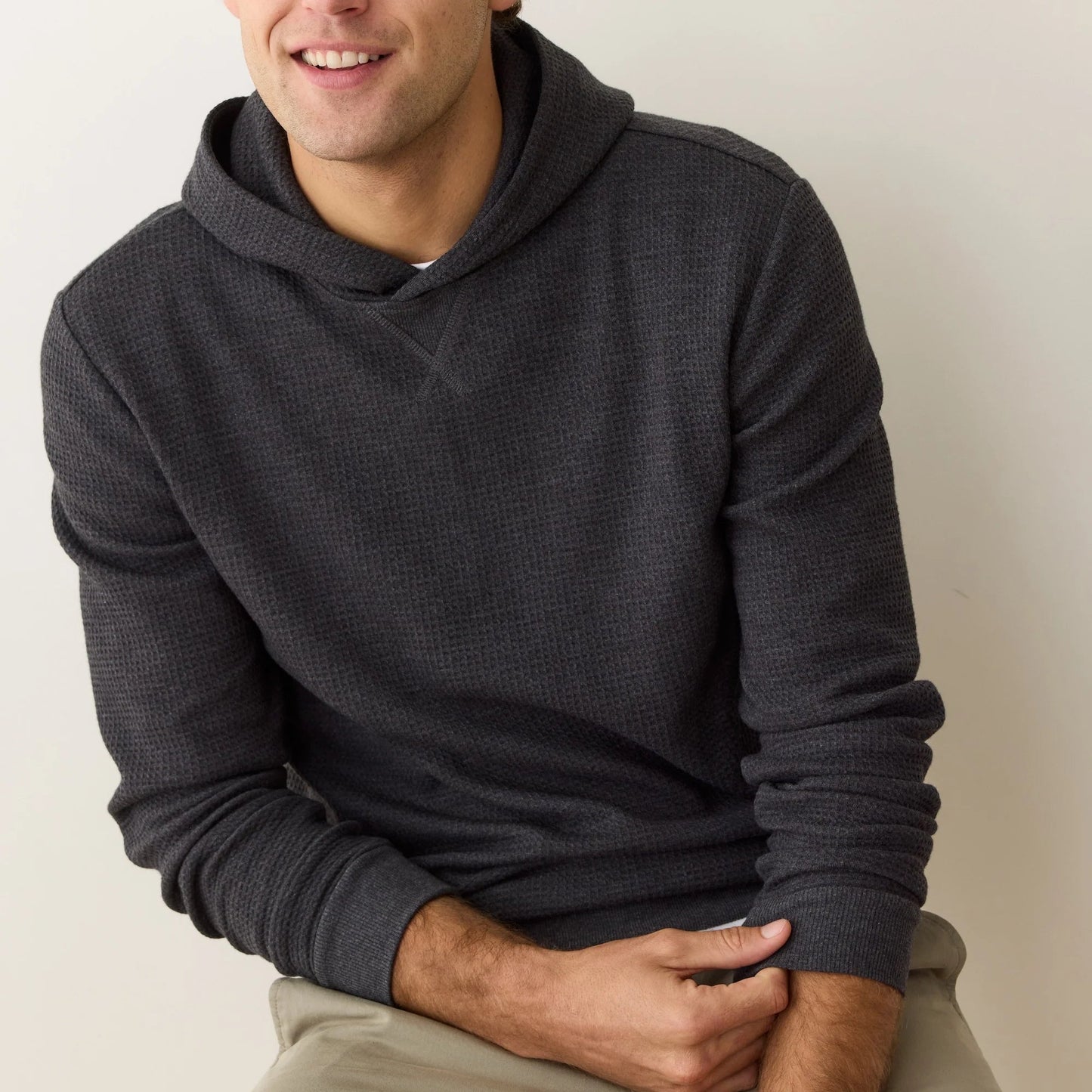 A man wearing a waffle knit hoodie from Marine Layer