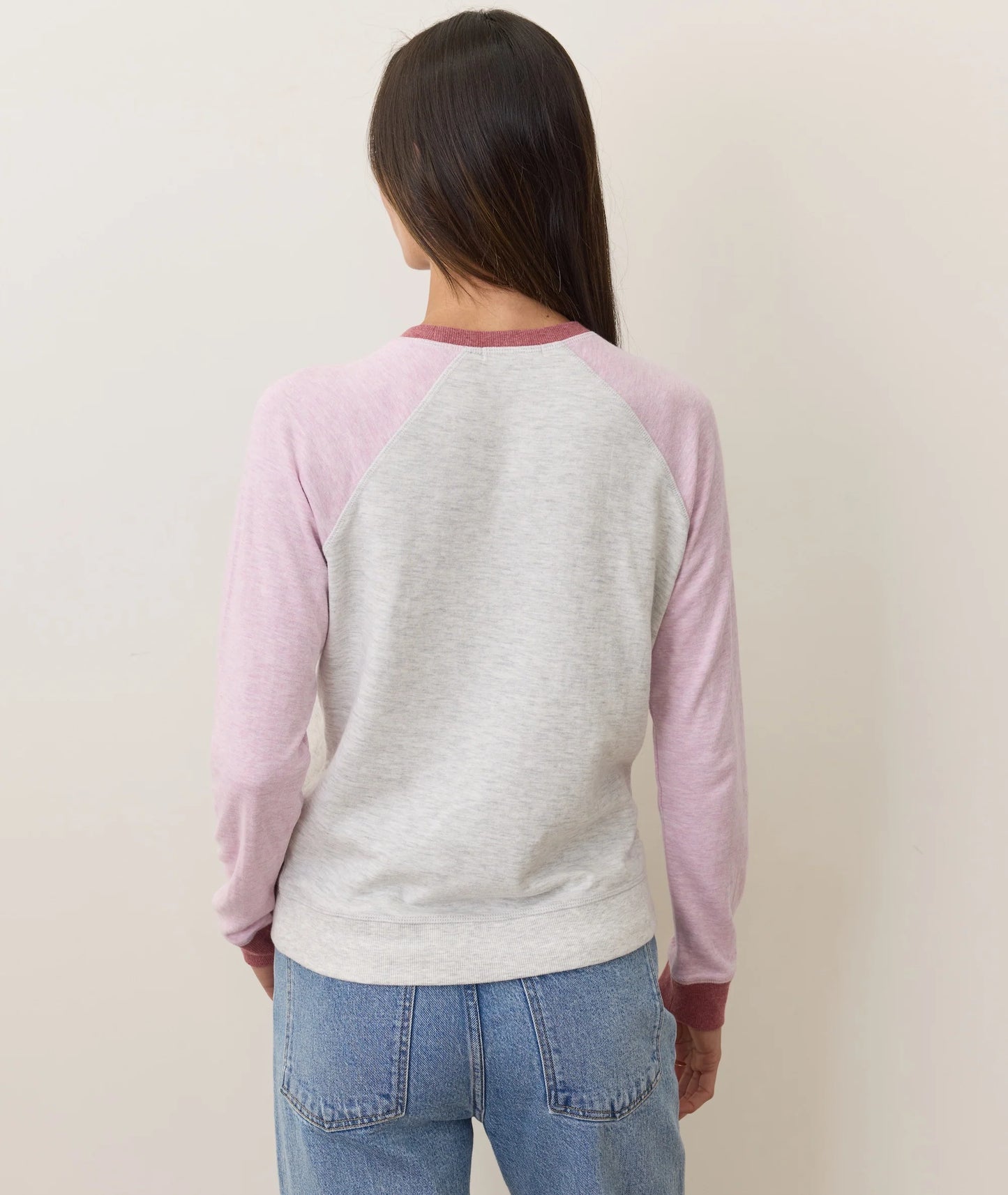 Woman wearing a long sleeve baseball tee from Marine Layer