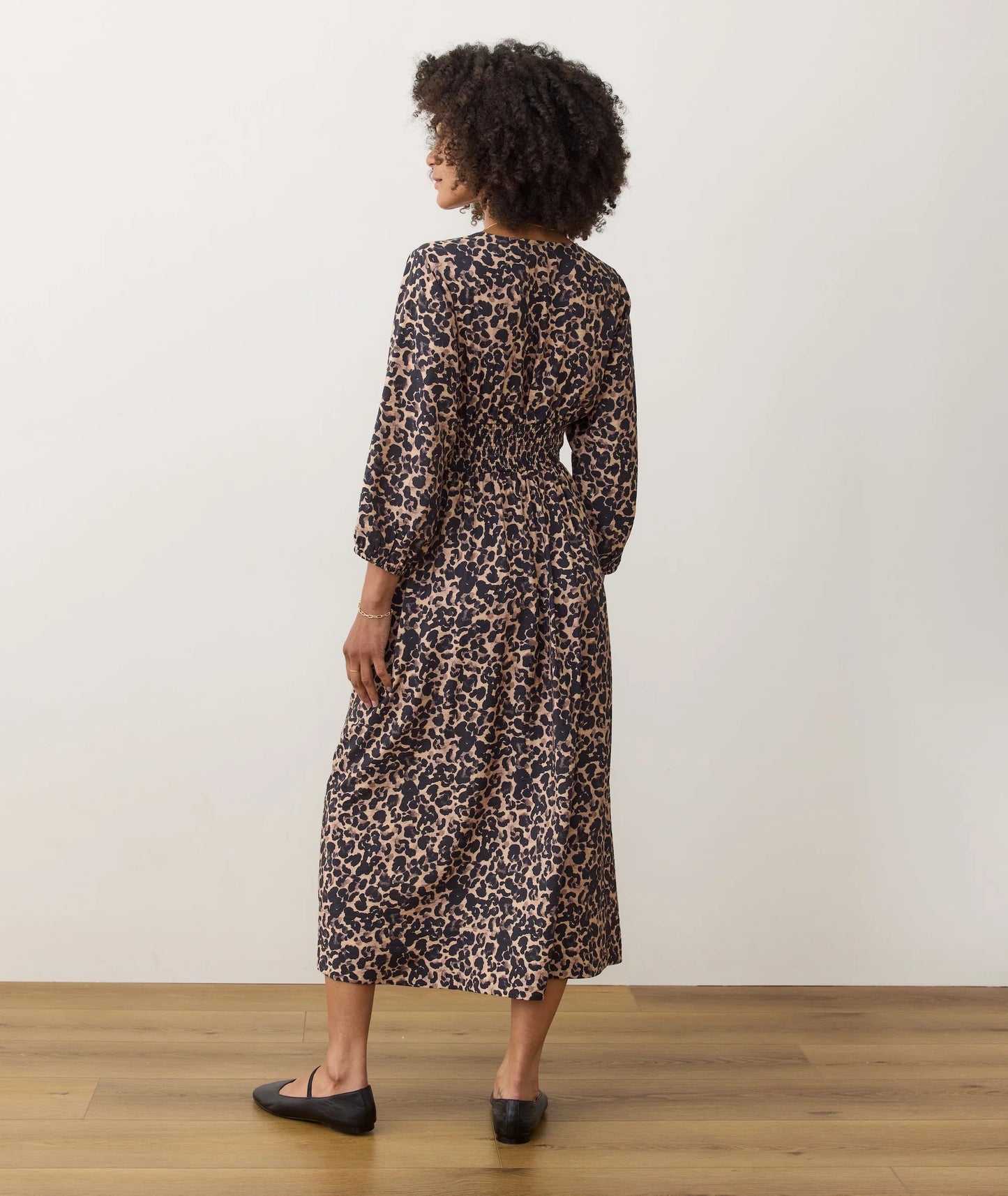 Woman wearing a leopard print dress with elbow length sleeves