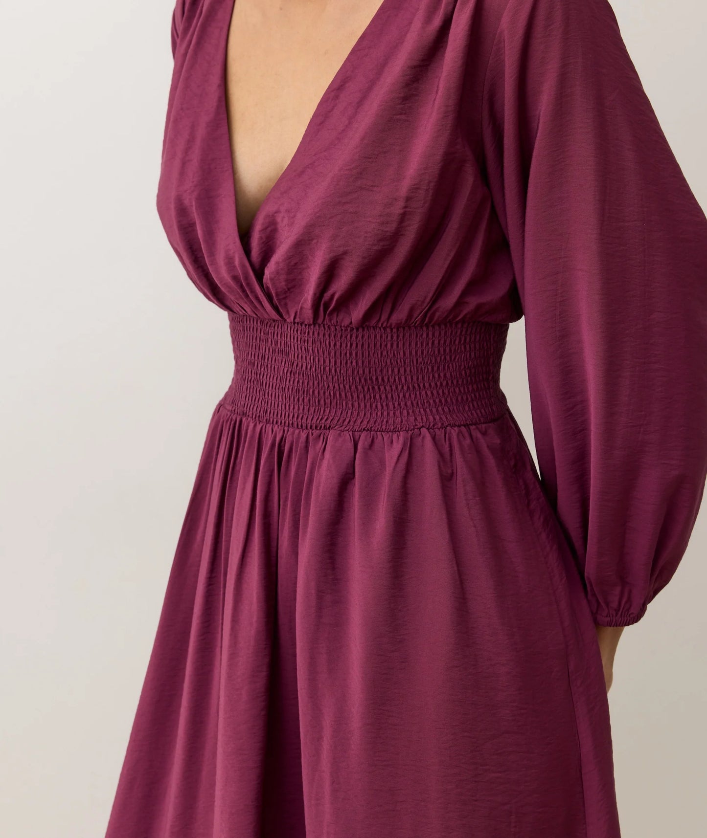 Dress with smocked waist and deep v-neckline