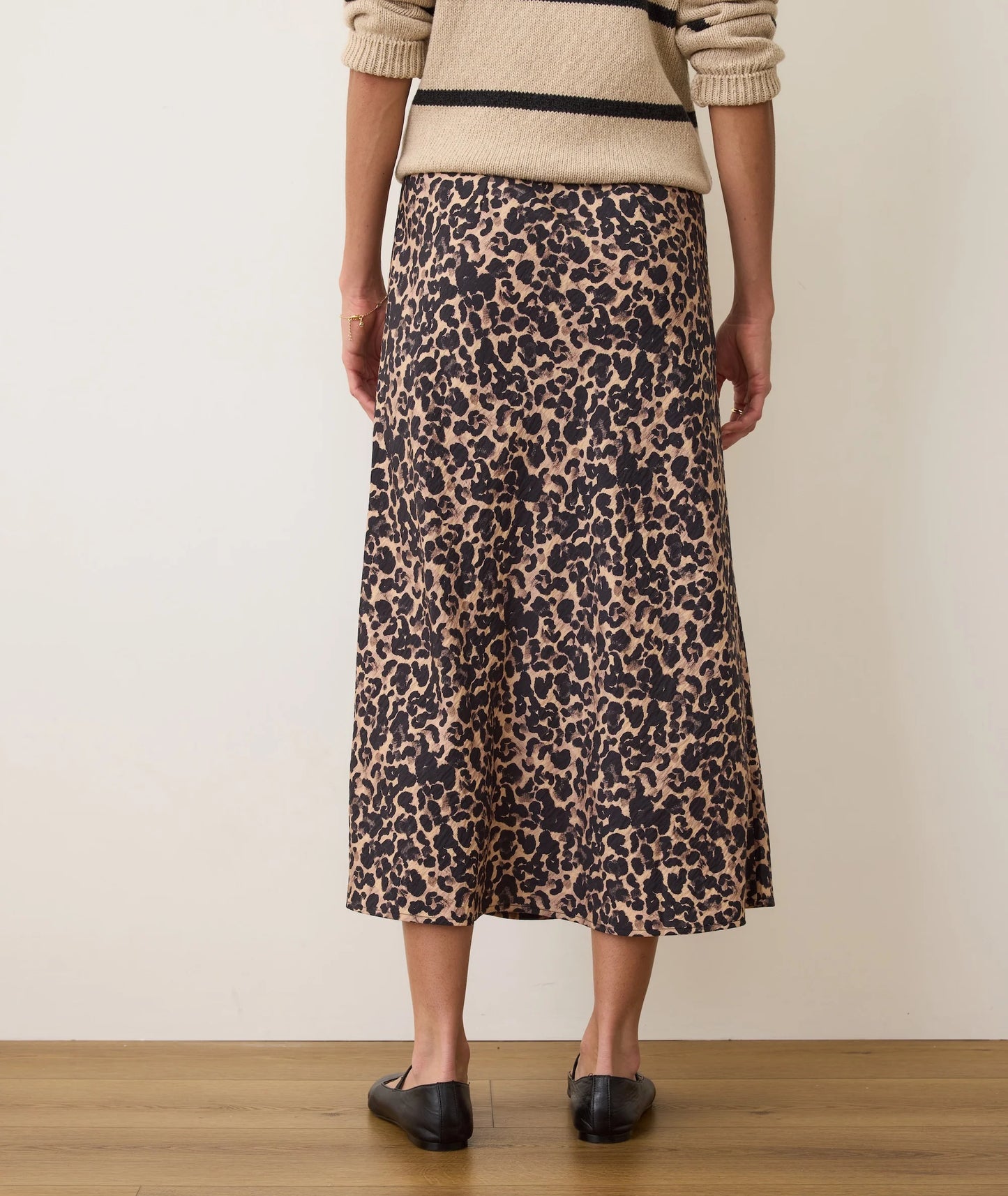Person wearing a leopard print skirt and oversized sweater from Marine Layer