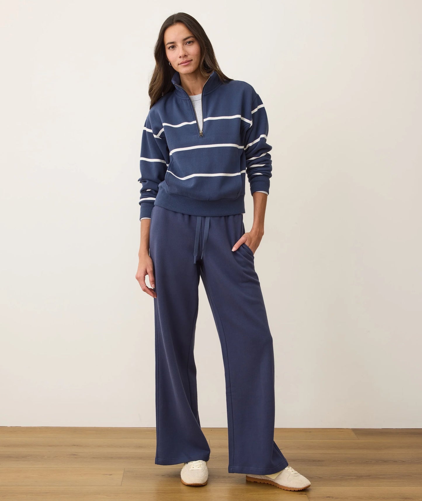 Woman wearing a navy striped sweater and wide-leg pants from Marine Layer