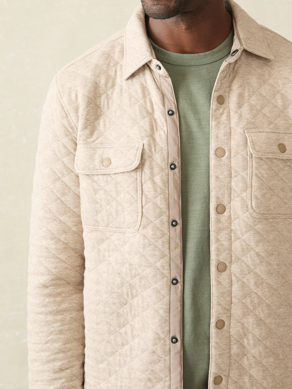 The Oatmeal Melange Epic Quilted Fleece CPO unbuttoned and layered over a green t-shirt