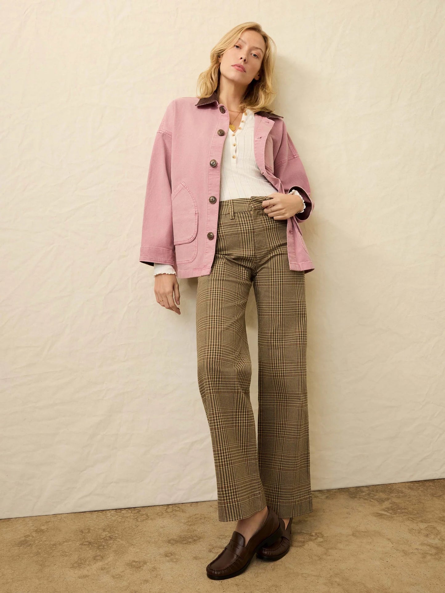 Woman wearing a pink blazer, white shirt, and plaid pants from Faherty
