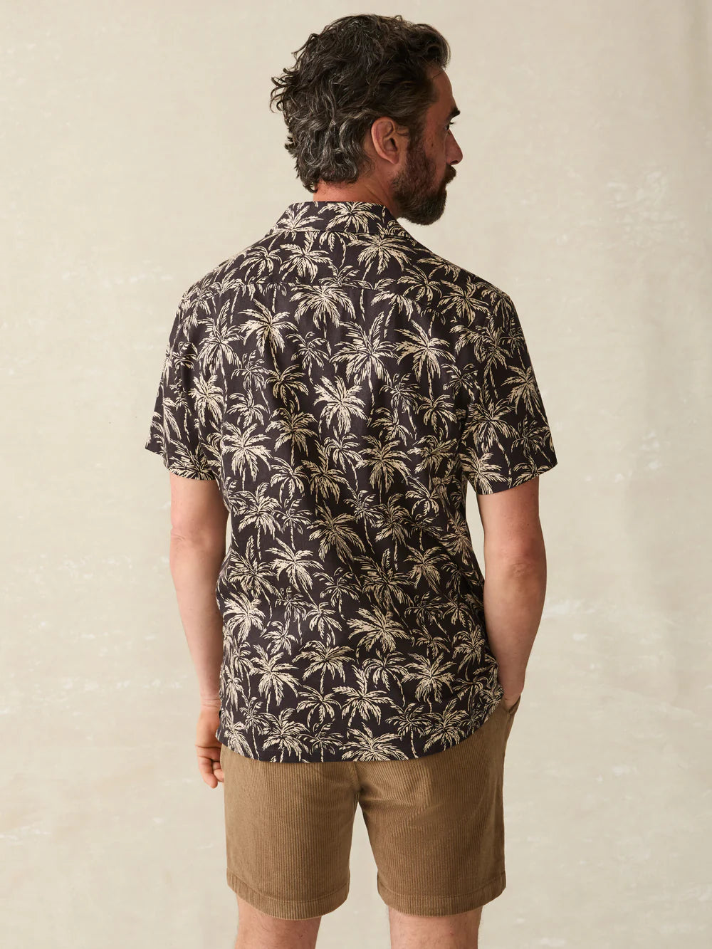 Back view of the Charcoal Tropic Trees Short Sleeve Hemp Blend Camp Shirt by Faherty