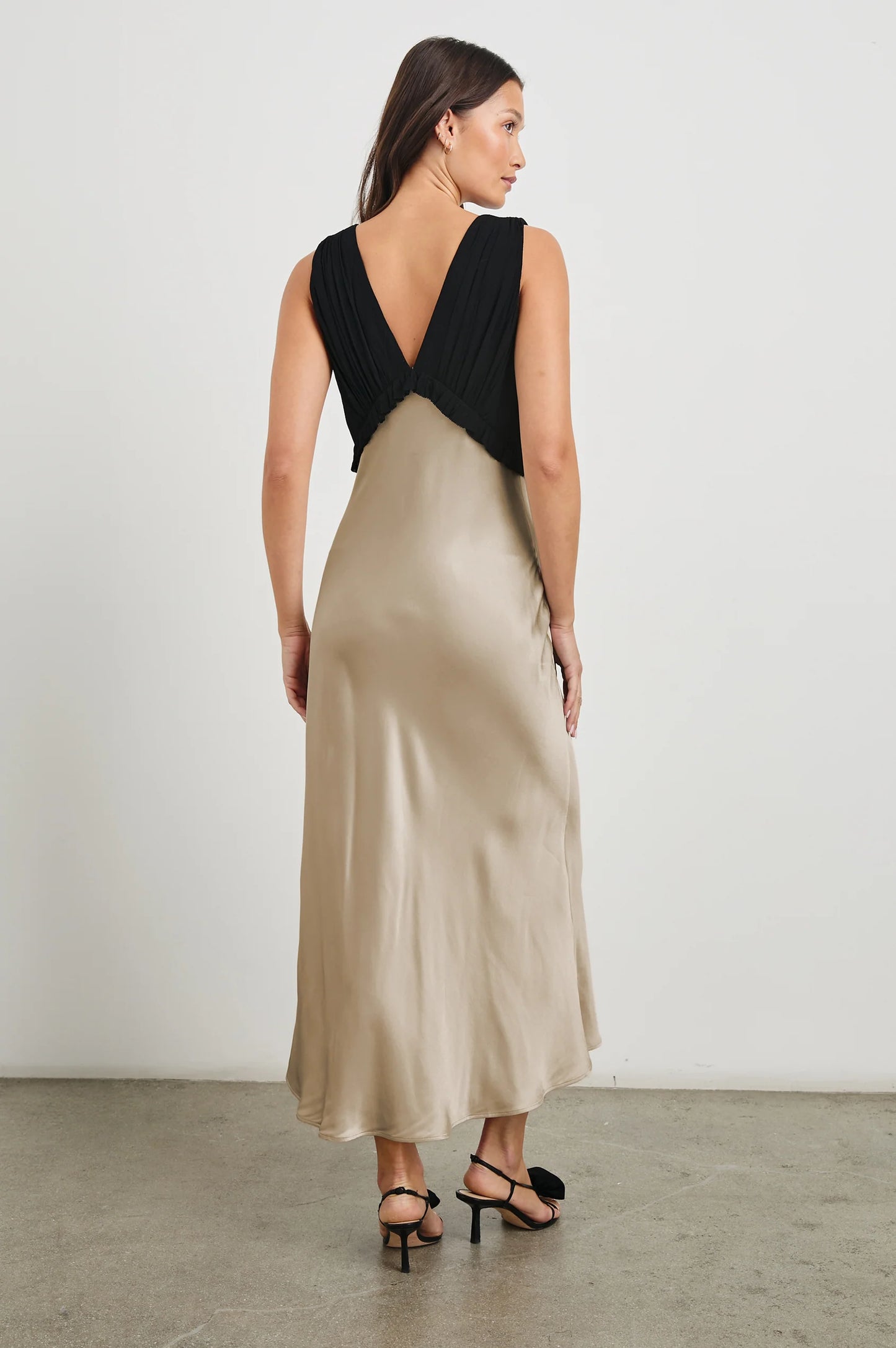 The Gilda Dress features a v-front and back