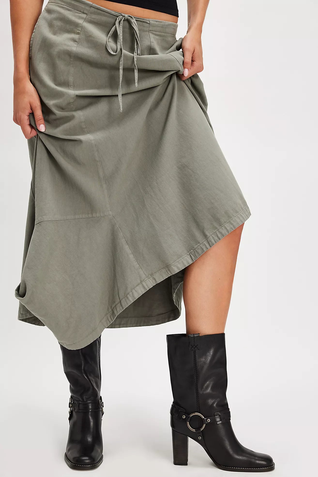 Person wearing a green skirt and the black Hayden Harness mid-calf boots