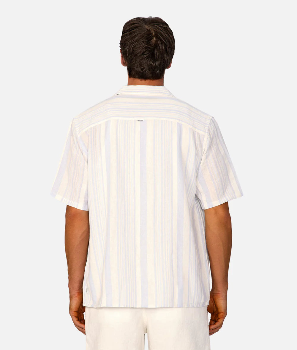 Man wearing a white striped shirt on a plain background